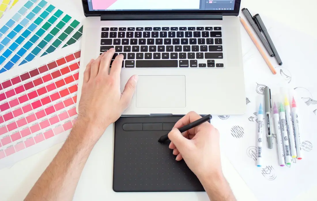 Designer working with colour swatches and a pen tablet